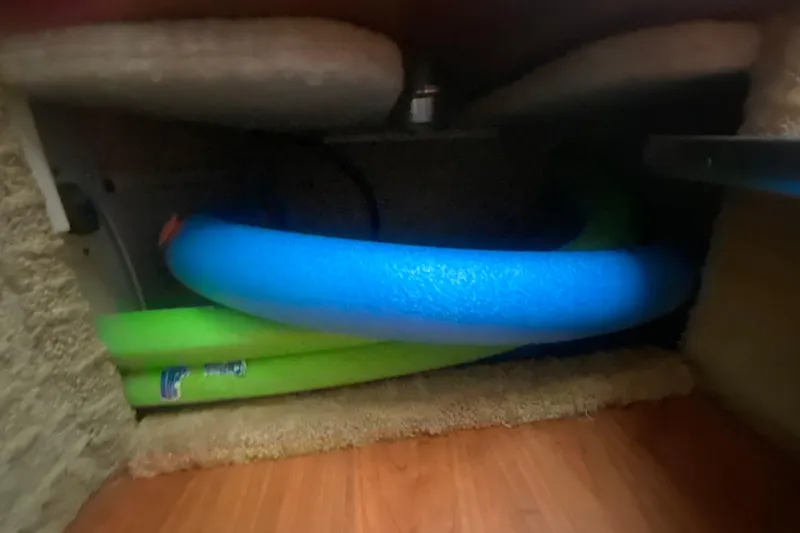 Slide: The Image of Storage compartment with colorful pool noodles on a 2007 Formula 310 Sun Sport boat. - 25