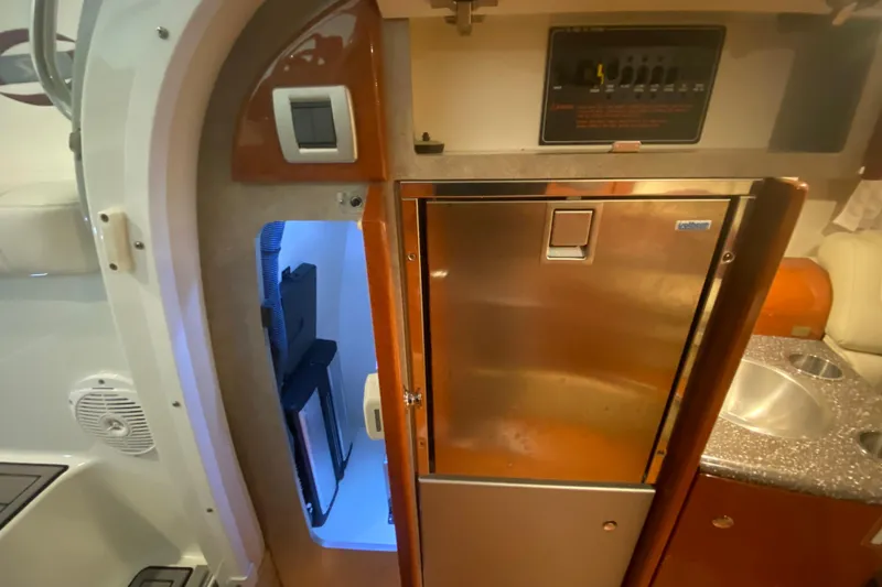 Slide: The Image of Interior of a 2007 Formula 310 Sun Sport boat featuring a compact kitchenette. - 26
