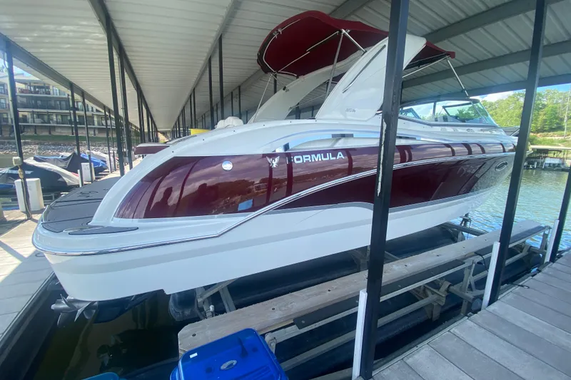 Slide: The Image of 2007 Formula 310 Sun Sport boat docked under a covered marina. - 3