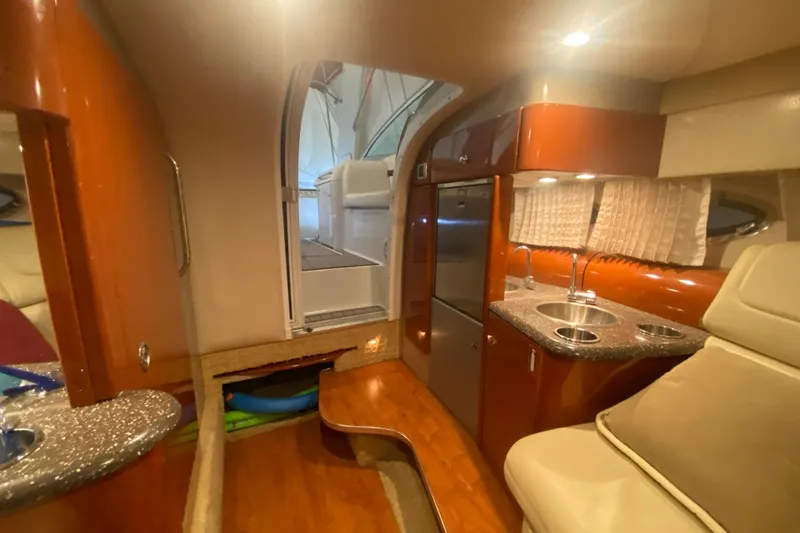 Slide: The Image of Interior of a 2007 Formula 310 Sun Sport boat with kitchenette and seating area. - 31