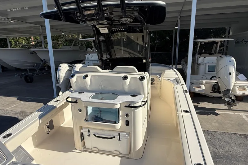 Slide: The Image of 2026 Scout 281 XSS boat interior with seating and storage, displayed in a showroom. - 10