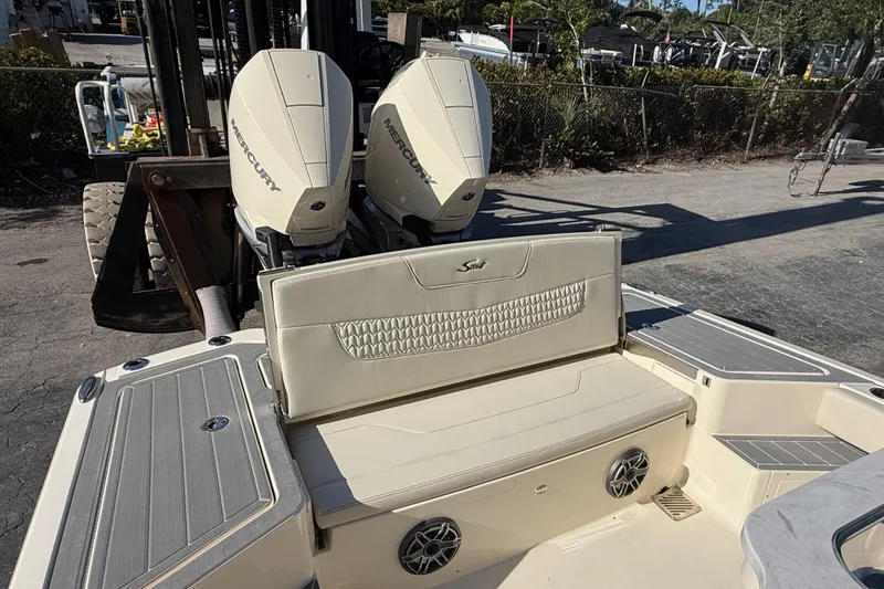 Slide: The Image of 2026 Scout 281 XSS boat with dual Mercury engines and beige seating. - 12