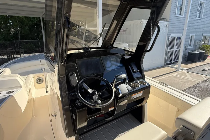 Slide: The Image of 2026 Scout 281 XSS boat cockpit with steering wheel and control panel. - 13
