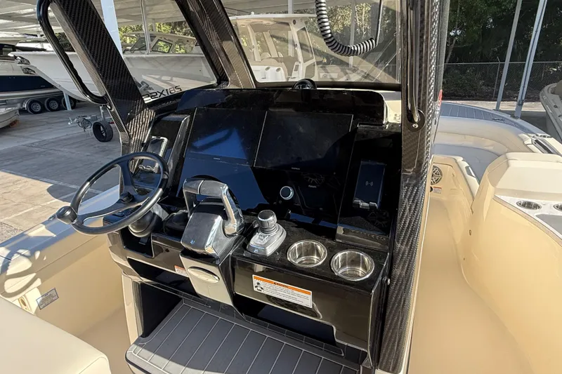 Slide: The Image of 2026 Scout 281 XSS boat dashboard with steering wheel and control panel. - 14