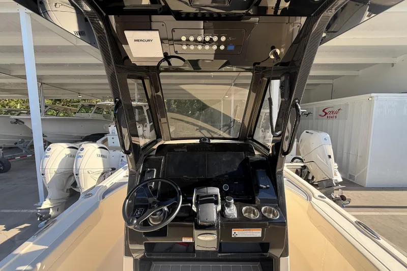 Slide: The Image of 2026 Scout 281 XSS boat dashboard with Mercury controls and steering wheel. - 15