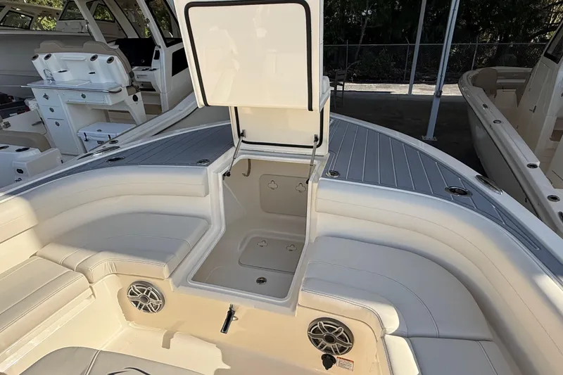 Slide: The Image of 2026 Scout 281 XSS boat interior with seating and storage compartments. - 18