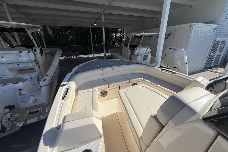 Slide: The Image of 2026 Scout 281 XSS boat interior with spacious seating under a covered area. - 20