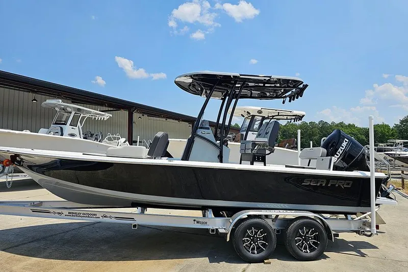 The Image of 2026 Sea Pro 230 Bay boat on trailer under clear blue sky. - 1