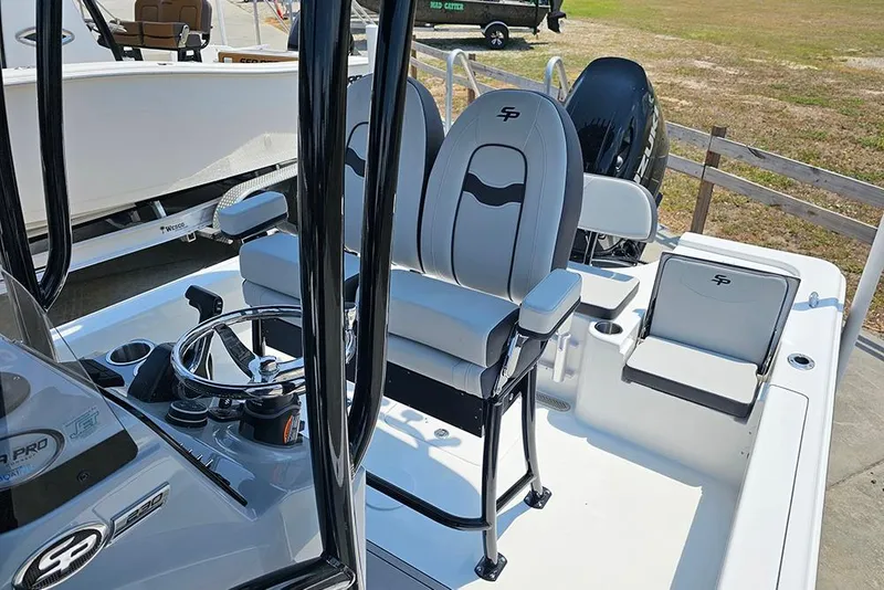 Slide: The Image of 2026 Sea Pro 230 Bay boat interior with steering console and seating. - 11