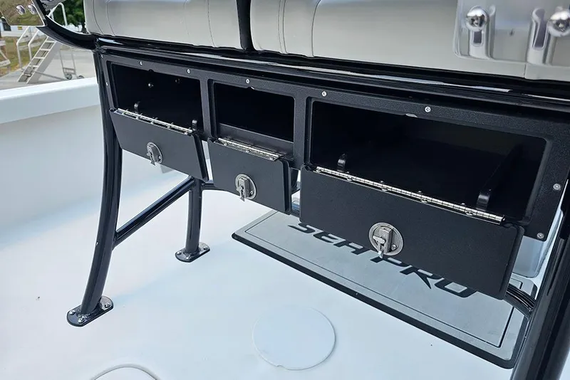 Slide: The Image of Storage compartments on a 2026 Sea Pro 230 Bay boat, featuring secure locking mechanisms. - 17