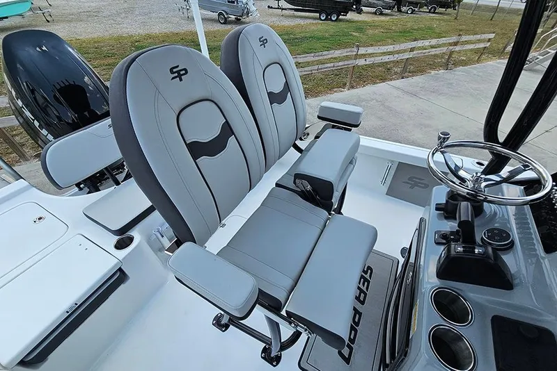 Slide: The Image of 2026 Sea Pro 230 Bay boat interior with dual seats and steering console. - 18