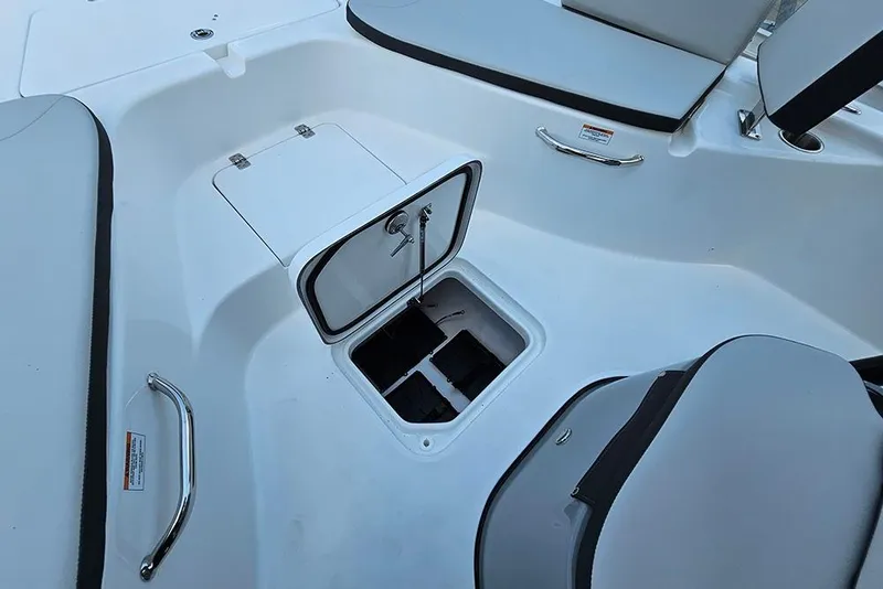 Slide: The Image of 2026 Sea Pro 230 Bay boat interior with open storage compartment and seating. - 22