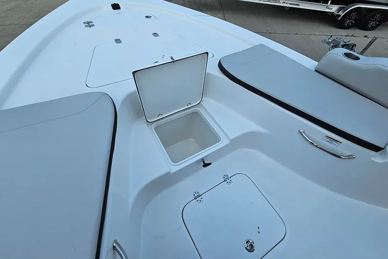 Slide: The Image of 2026 Sea Pro 230 Bay boat deck with open storage compartment and seating. - 23