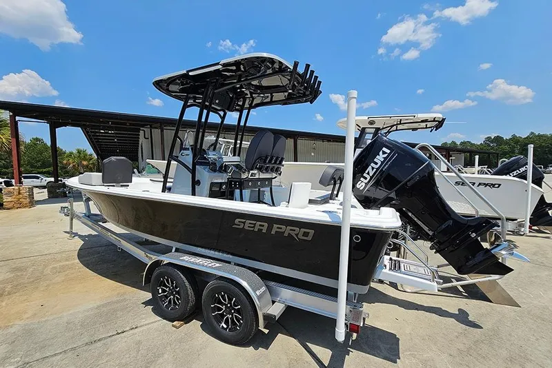 Slide: The Image of 2026 Sea Pro 230 Bay boat with Suzuki engine on trailer, outdoors under blue sky. - 3