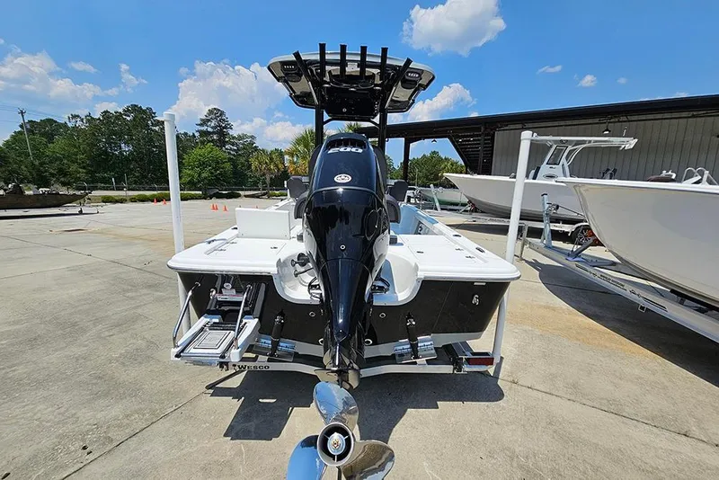 Slide: The Image of 2026 Sea Pro 230 Bay boat with powerful outboard motor, parked outdoors. - 7