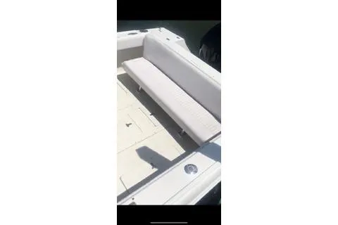 Slide: The Image of 2001 Intrepid 322 Cuddy boat interior with white seating and clean deck. - 11
