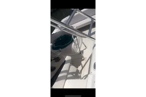 Slide: The Image of 2001 Intrepid 322 Cuddy boat deck with steering wheel and railing. - 14