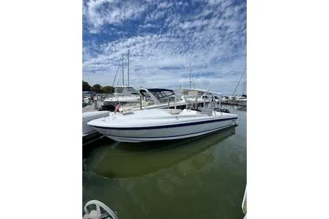 Slide: The Image of 2001 Intrepid 322 Cuddy boat docked under a partly cloudy sky. - 5