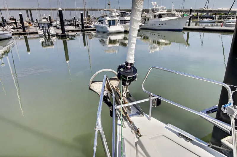 Slide: The Image of Beneteau Oceanis 48 sailboat docked in a marina, calm waters, 2012 model. - 11