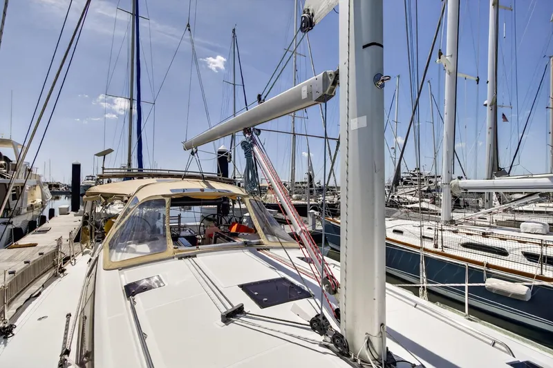 Slide: The Image of 2012 Beneteau Oceanis 48 sailboat docked at marina under clear blue sky. - 13