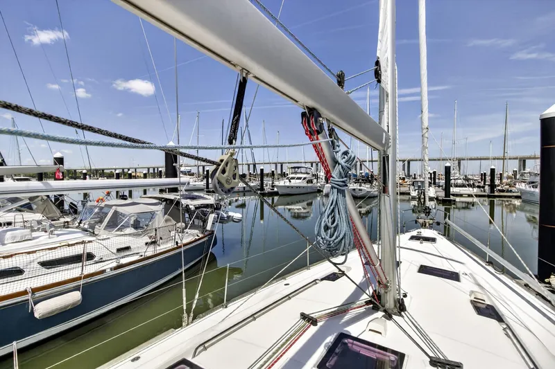 Slide: The Image of Beneteau Oceanis 48 sailboat docked in a marina, 2012 model, clear blue sky. - 14