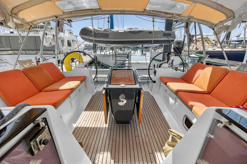 Slide: The Image of Spacious cockpit of 2012 Beneteau Oceanis 48 with orange cushions and dual steering wheels. - 25