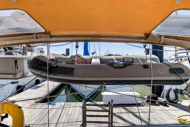Slide: The Image of Beneteau Oceanis 48 (2012) yacht with inflatable dinghy on deck at marina. - 26