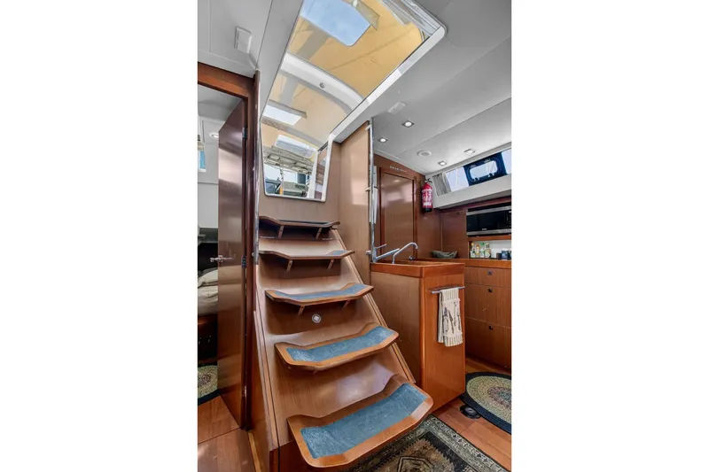 Slide: The Image of Interior of 2012 Beneteau Oceanis 48 yacht with wooden stairs and modern kitchen. - 28