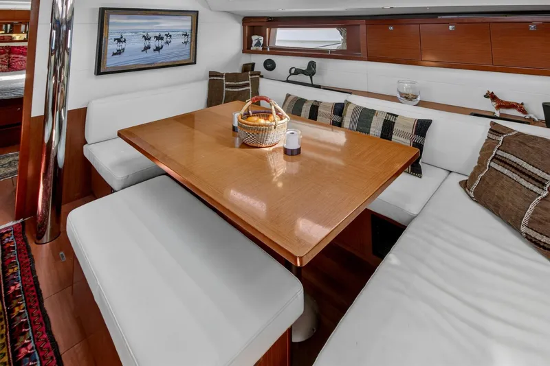 Slide: The Image of Luxurious interior of 2012 Beneteau Oceanis 48 yacht with elegant dining area and plush seating. - 32