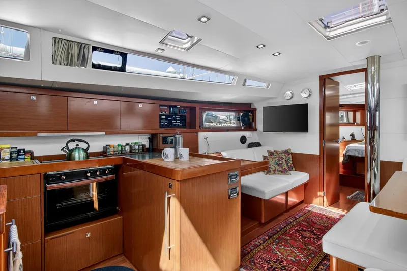 Slide: The Image of Luxurious interior of 2012 Beneteau Oceanis 48 yacht with modern kitchen and cozy seating area. - 34