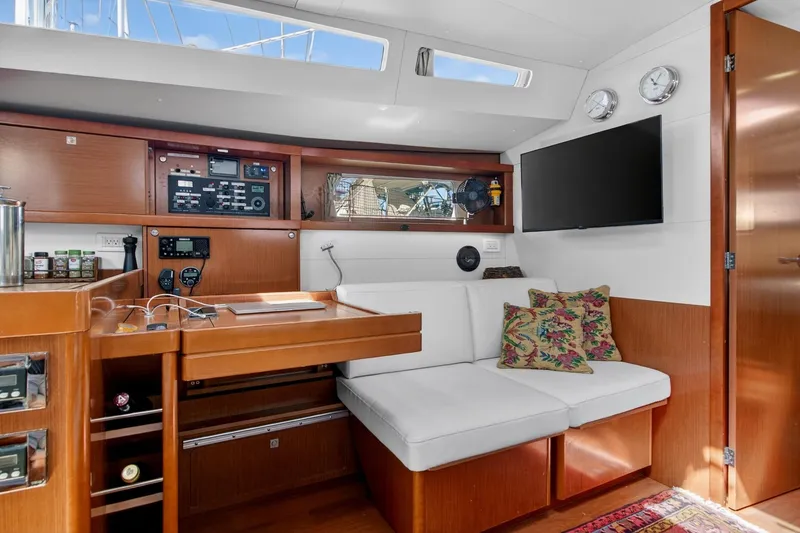 Slide: The Image of Interior of 2012 Beneteau Oceanis 48 yacht with modern seating, control panel, and TV. - 35