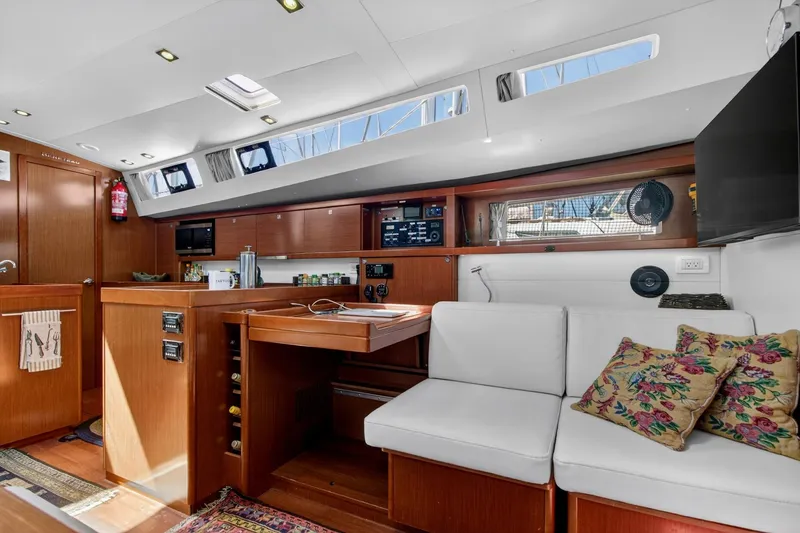 Slide: The Image of Interior of 2012 Beneteau Oceanis 48 yacht with modern kitchen and seating area. - 36