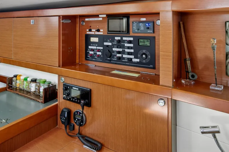 Slide: The Image of Control panel and storage area inside a 2012 Beneteau Oceanis 48 yacht. - 37