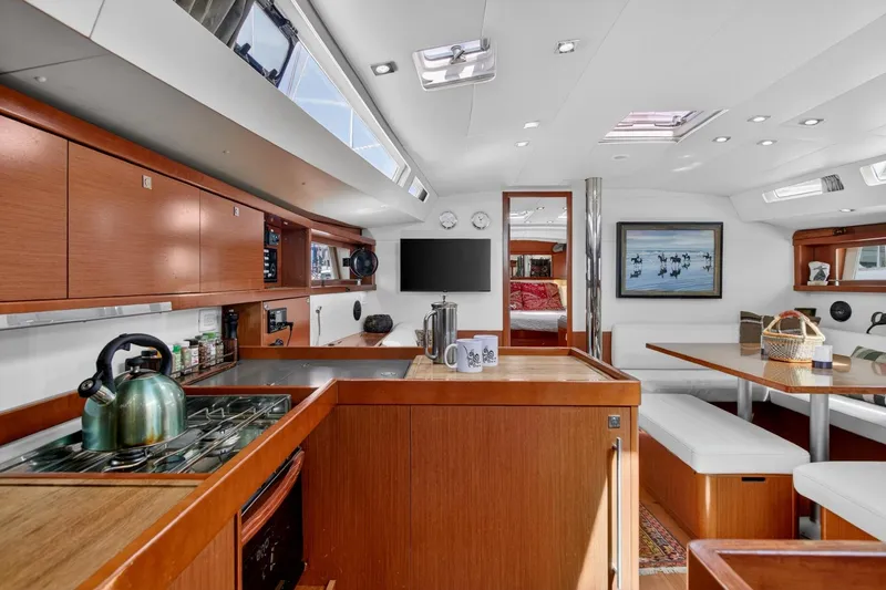 Slide: The Image of Luxurious interior of 2012 Beneteau Oceanis 48 yacht with modern kitchen and dining area. - 39