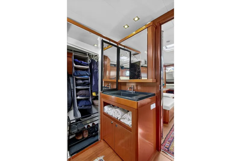 Slide: The Image of Luxurious interior of 2012 Beneteau Oceanis 48 yacht featuring a sleek bathroom and organized closet. - 43