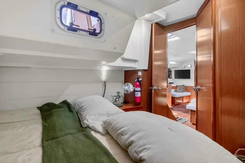 Slide: The Image of Cozy cabin interior of 2012 Beneteau Oceanis 48 yacht with wooden finishes and comfortable bedding. - 51