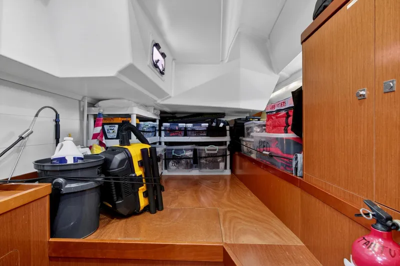 Slide: The Image of Storage area inside a 2012 Beneteau Oceanis 48 yacht, featuring organized equipment and supplies. - 52