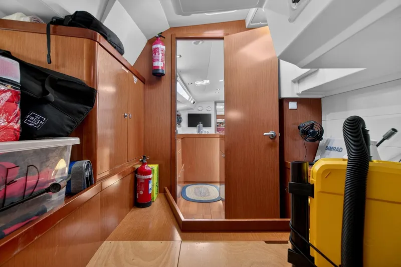 Slide: The Image of Interior of 2012 Beneteau Oceanis 48 yacht with wooden cabinetry and storage. - 53