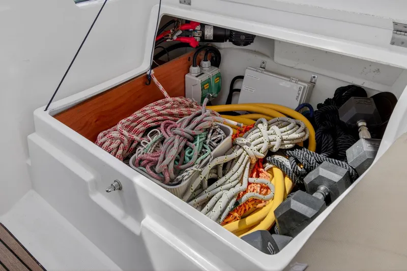 Slide: The Image of Storage compartment of 2012 Beneteau Oceanis 48 with ropes, cables, and weights. - 54