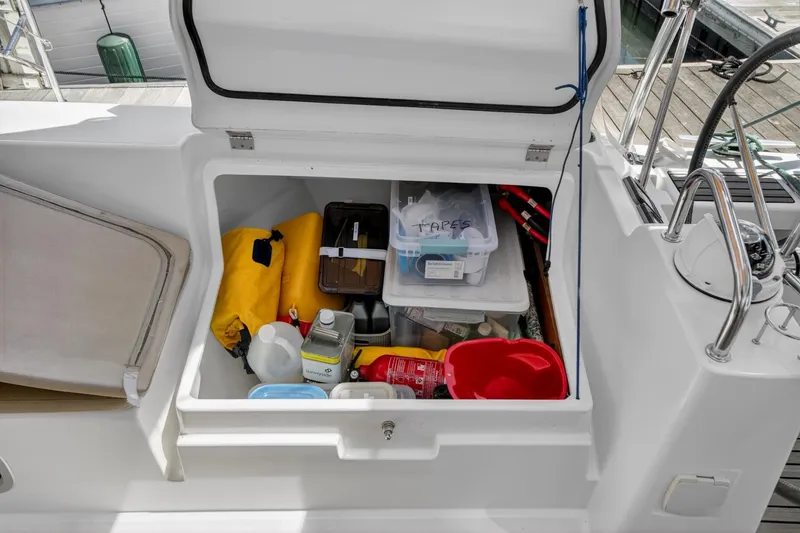 Slide: The Image of Storage compartment on a 2012 Beneteau Oceanis 48 sailboat, filled with various supplies. - 55
