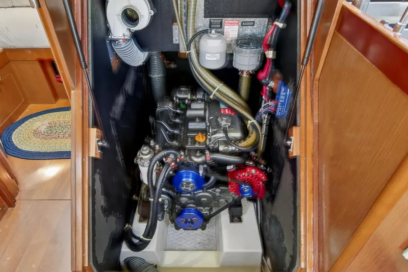 Slide: The Image of Engine compartment of a 2012 Beneteau Oceanis 48 sailboat, showcasing mechanical components. - 59