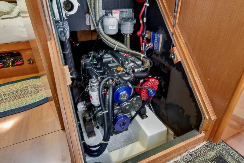 Slide: The Image of Engine compartment of a 2012 Beneteau Oceanis 48 sailboat, showcasing mechanical components. - 60