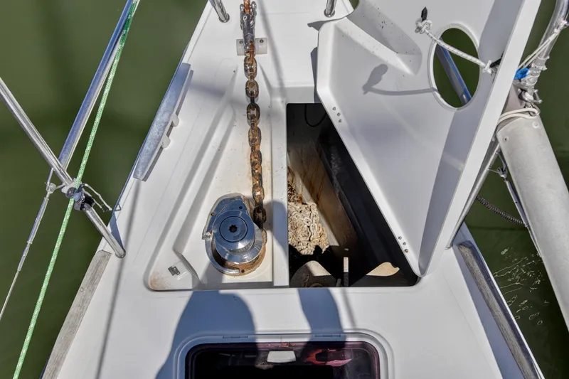 Slide: The Image of Anchor chain locker on a 2012 Beneteau Oceanis 48 sailboat, open with visible chain. - 62