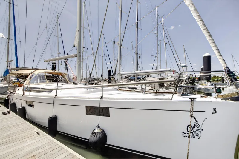 Slide: The Image of 2012 Beneteau Oceanis 48 sailboat docked at marina, showcasing sleek design and modern features. - 9