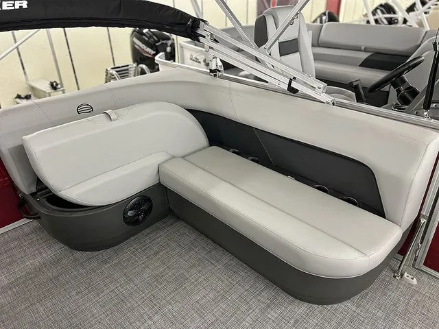 Slide: The Image of Interior of Sun Tracker Party Barge 16 DLX 2026 with gray seating. - 7