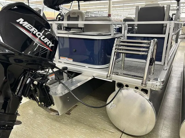 Slide: The Image of Sun Tracker Bass Buggy 18 DLX 2026 with Mercury engine, side view. - 15