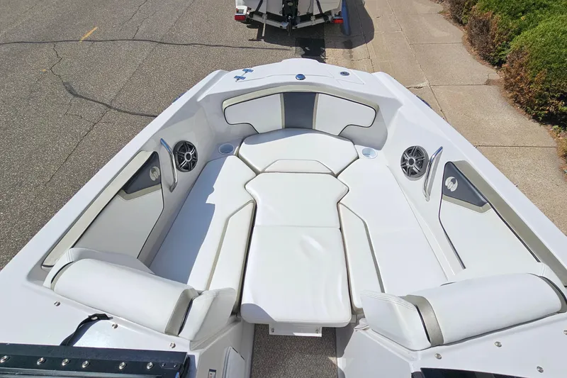 Slide: The Image of 2014 Scarab 215 boat interior with white seating and built-in speakers. - 18