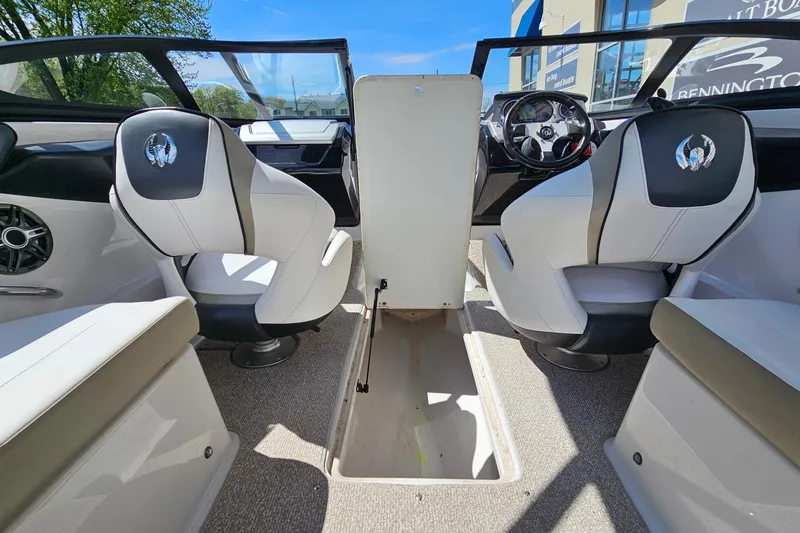 Slide: The Image of Interior of a 2014 Scarab 215 boat with modern seating and steering wheel. - 23
