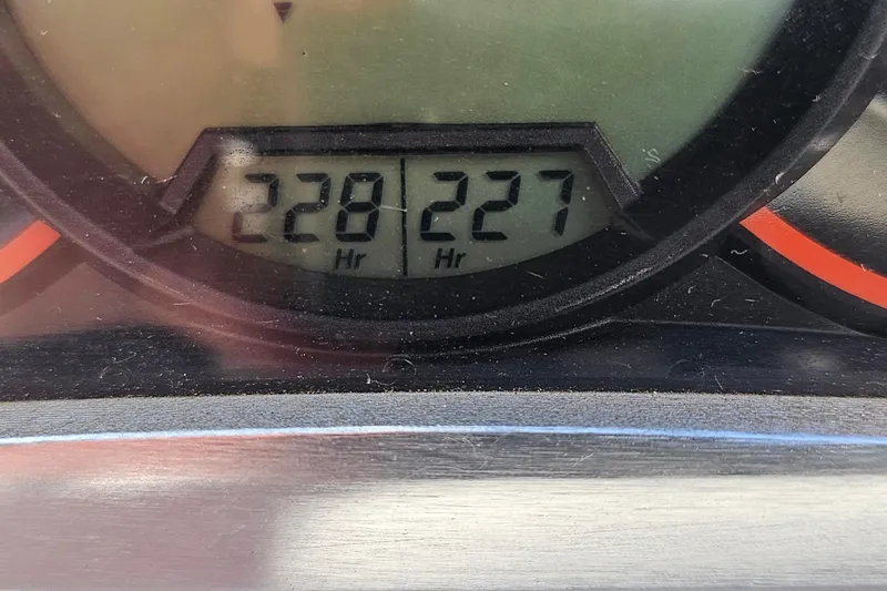 Slide: The Image of Close-up of 2014 Scarab 215 hour meter displaying 228 and 227 hours. - 25