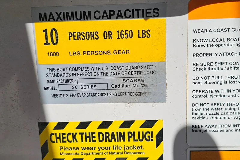 Slide: The Image of Scarab 215 boat capacity label, 10 persons or 1650 lbs, safety instructions visible. - 26